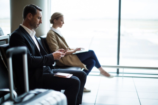 Businessman using mobile phone in waiting area